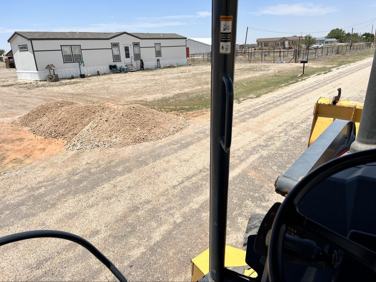 View from the backhoe cab on a job site