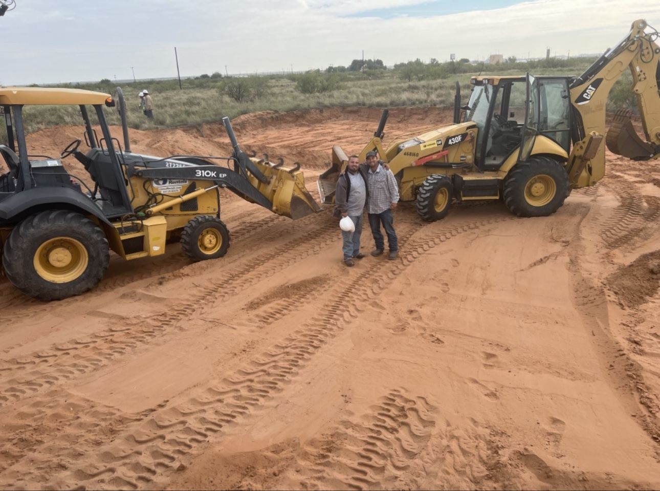 Can You Dig It crew with two backhoes on a job site