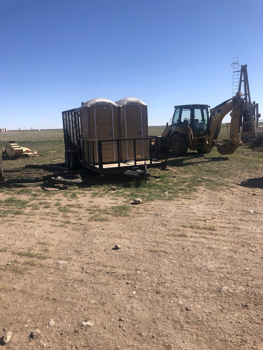Porta potty units staged on an oilfield job site