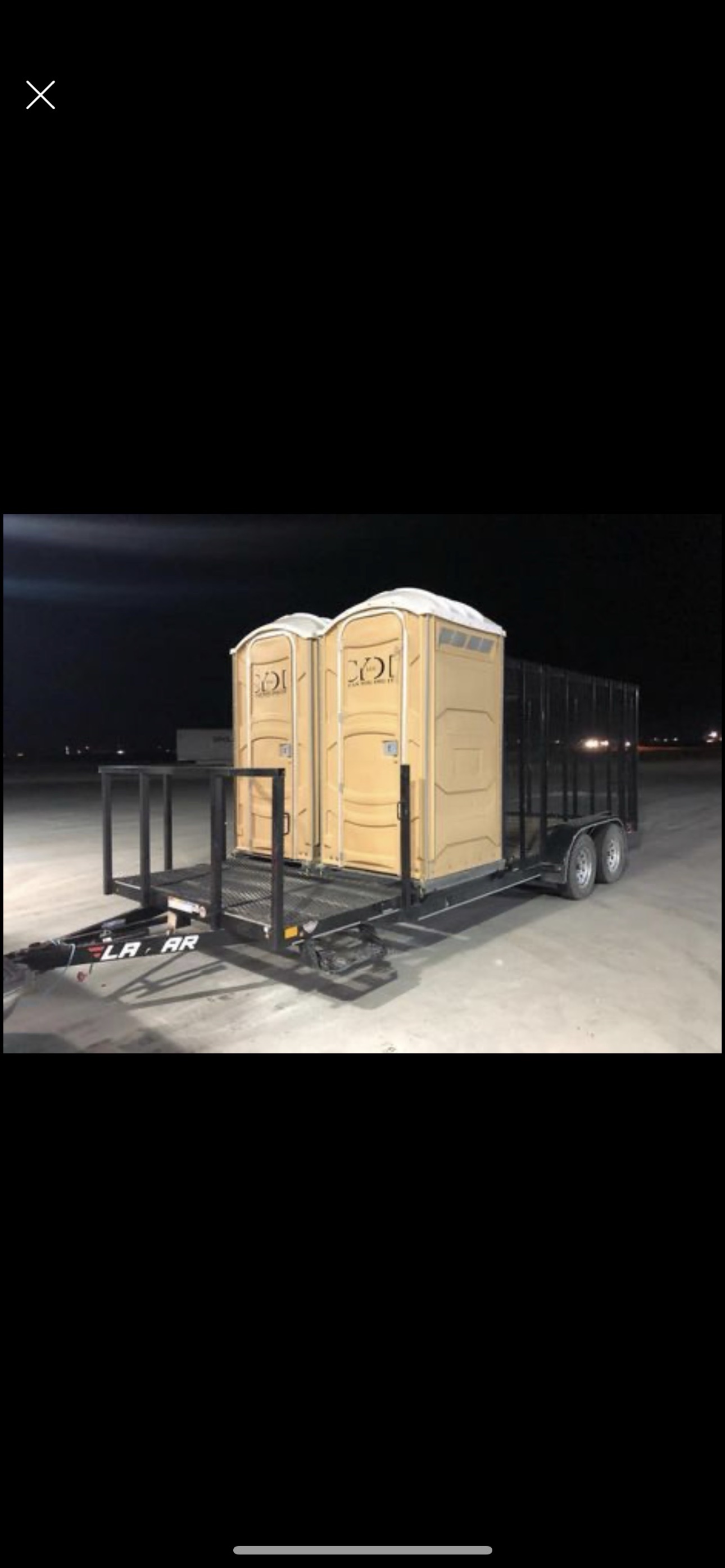 Porta potty and trash trailer combo unit at night